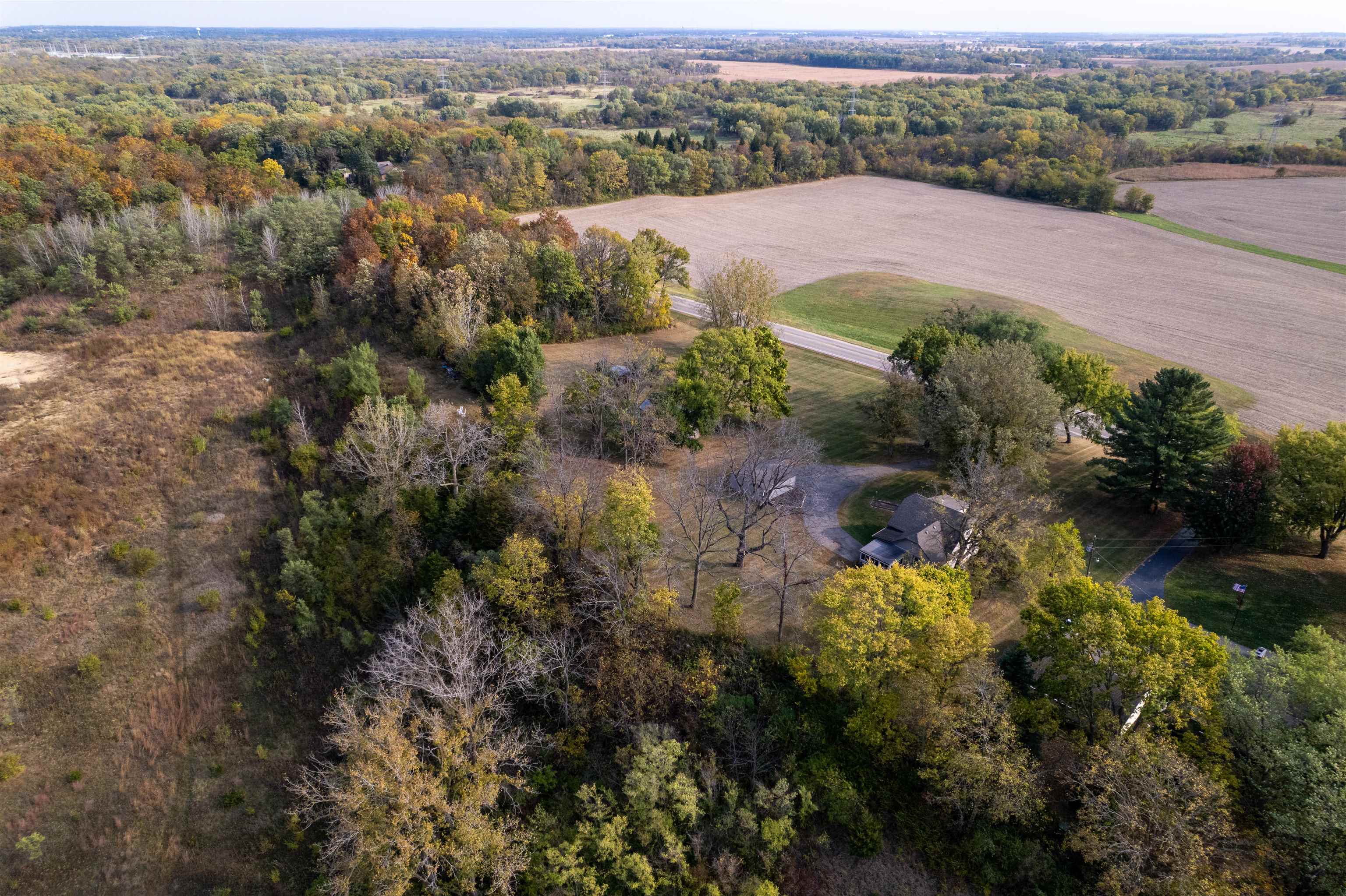 6155 South Perryville Road Cherry Valley, IL 61016 - Photo 14 of 92 an aerial view of a houses with a lush green hillside