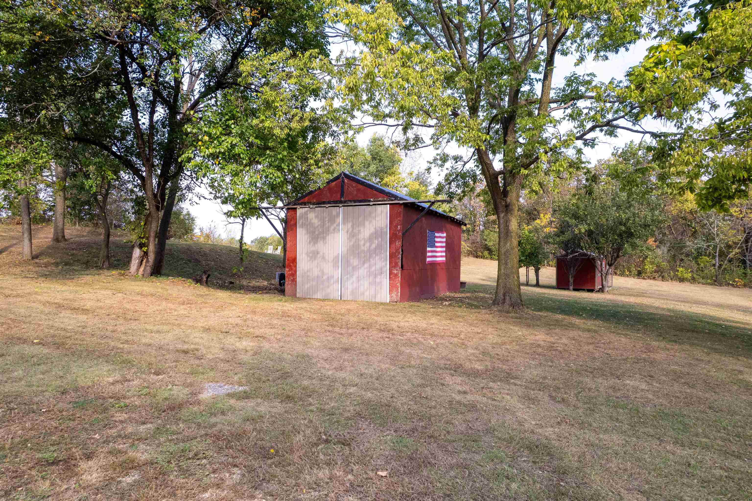 6155 South Perryville Road Cherry Valley, IL 61016 - Photo 16 of 92 a house with trees in front of it