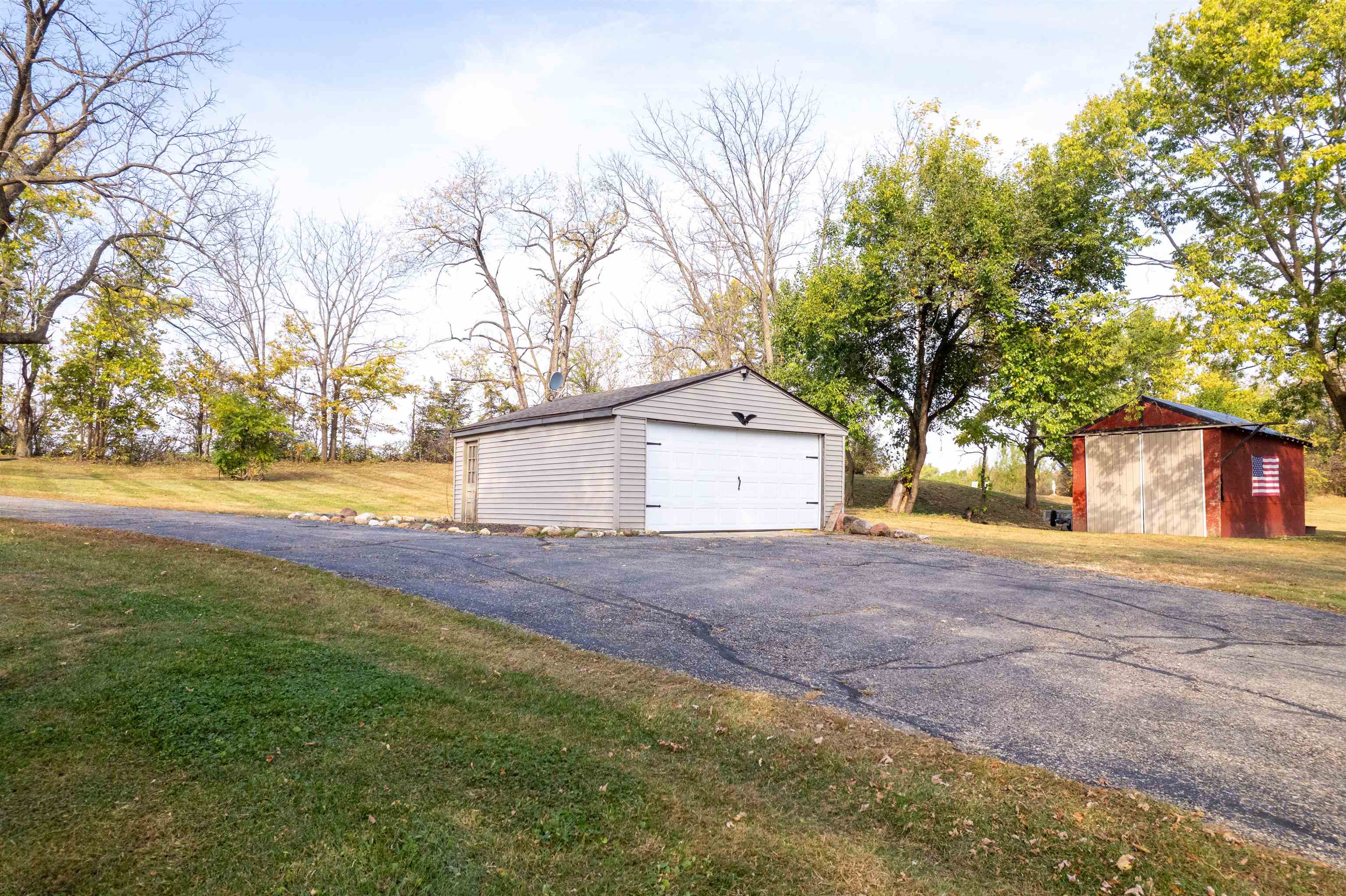 6155 South Perryville Road Cherry Valley, IL 61016 - Photo 2 of 92 a view of a yard with a house and a large tree