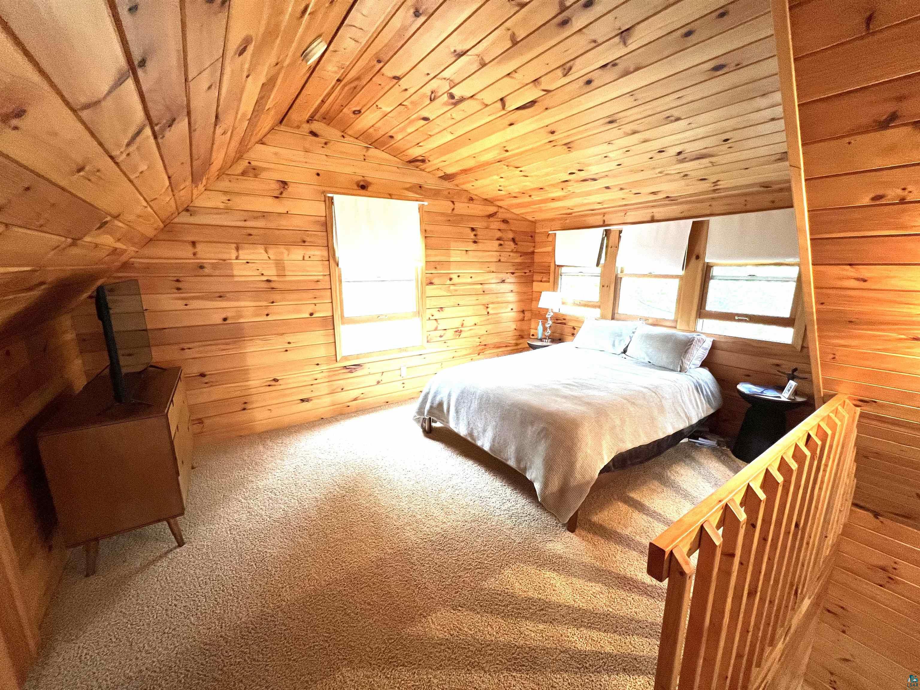 4366 Wood Ridge Drive Two Harbors, MN 55616 - Photo 12 of 21 Carpeted bedroom with wood ceiling, wooden walls, and lofted ceiling