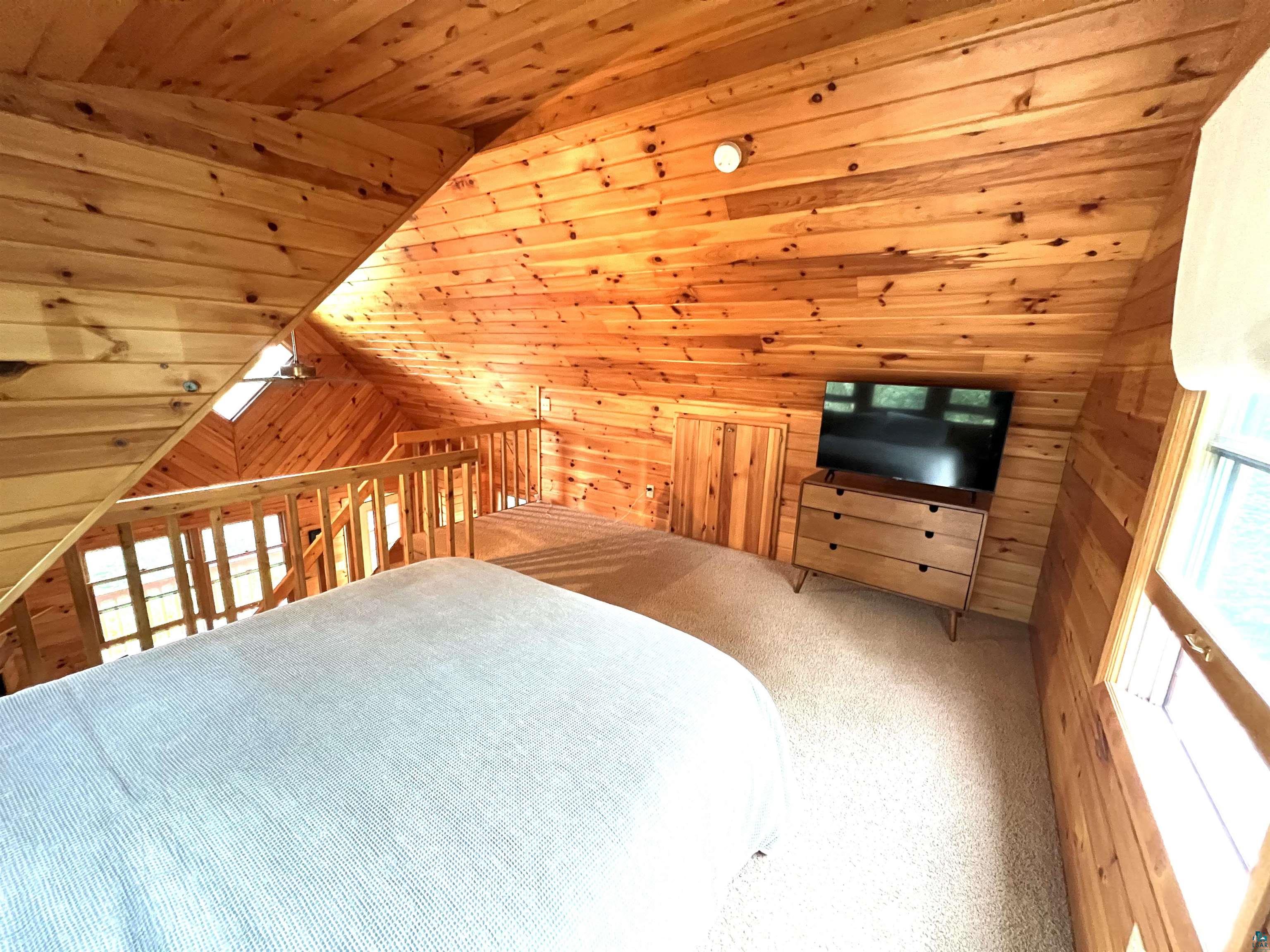 4366 Wood Ridge Drive Two Harbors, MN 55616 - Photo 13 of 21 Bonus room featuring wood ceiling, lofted ceiling, and wood walls