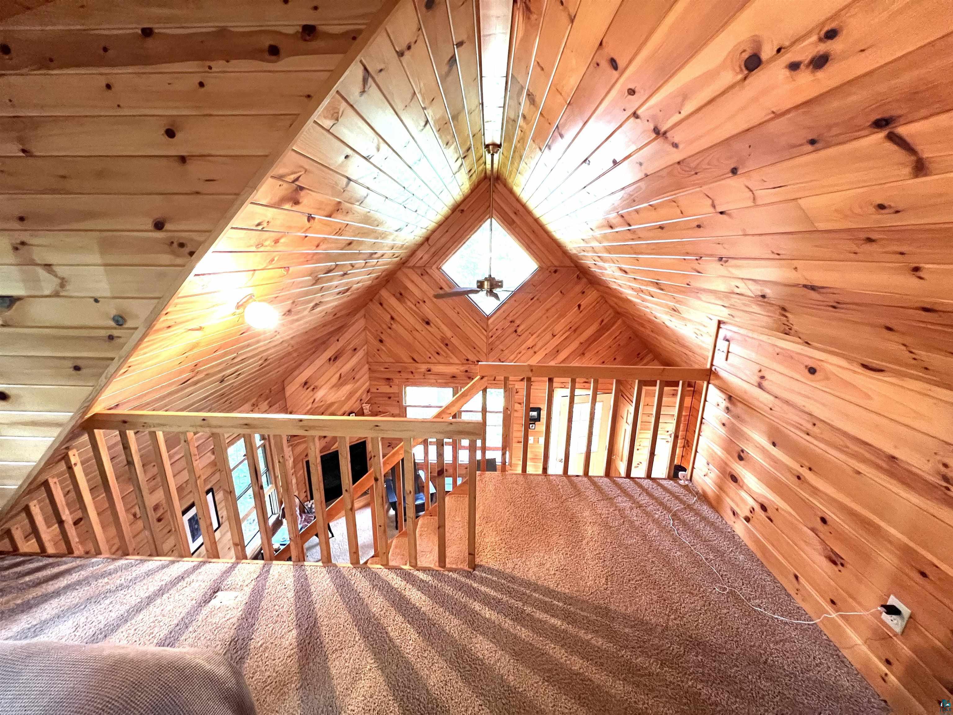 4366 Wood Ridge Drive Two Harbors, MN 55616 - Photo 14 of 21 Additional living space with carpet flooring, lofted ceiling, and wood ceiling