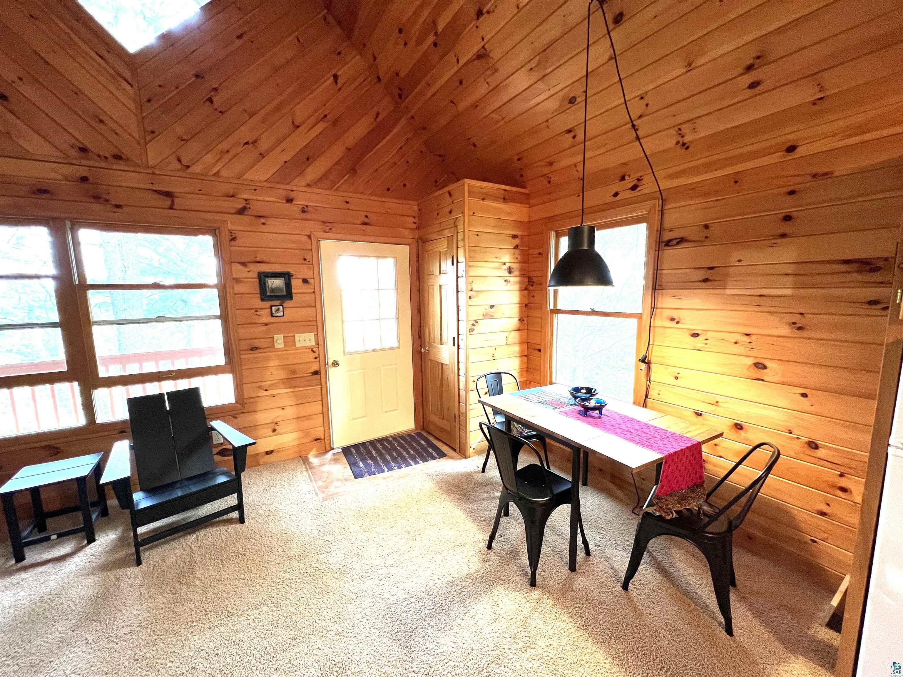 4366 Wood Ridge Drive Two Harbors, MN 55616 - Photo 5 of 21 Carpeted home office featuring high vaulted ceiling, wood walls, and wooden ceiling