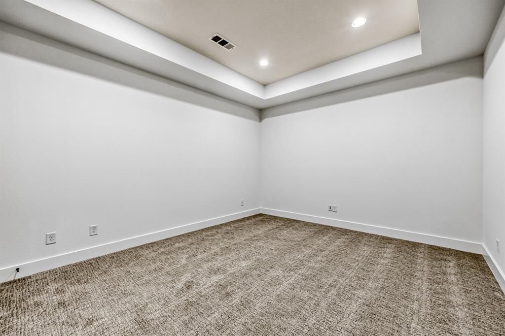 147 Derrett Lane Rhome, TX 76078 - Photo 19 of 28 Empty room featuring recessed lighting, light colored carpet, and a raised ceiling