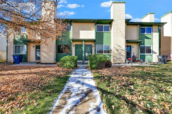 front view of a brick house with a yard
