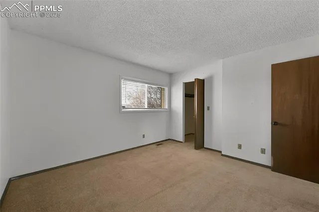 a view of an empty room and closet