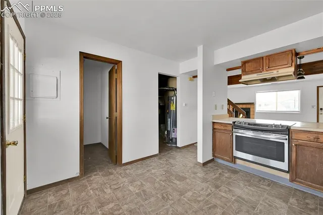 a kitchen with stainless steel appliances granite countertop a refrigerator and a stove