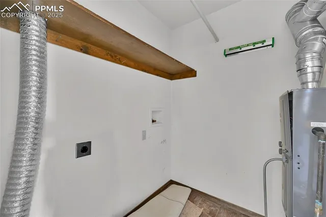 a view of an empty room with stairs and a ceiling fan