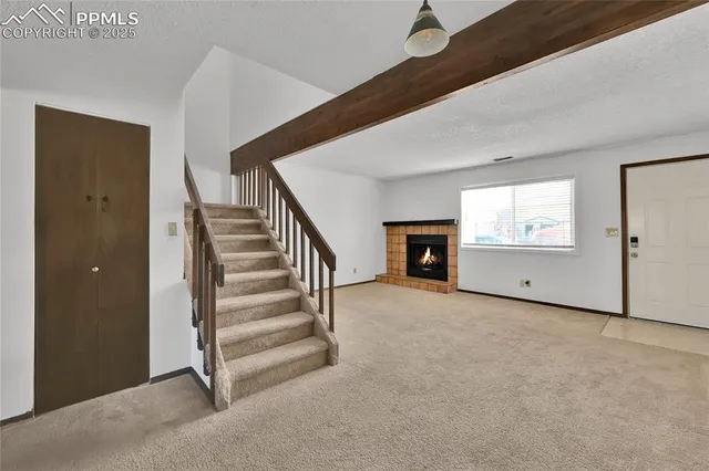 a kitchen with granite countertop a sink dishwasher a stove and a microwave oven with cabinets