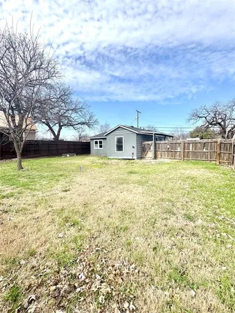 a view of a large pool with an outdoor space and seating area