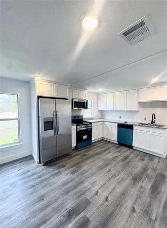 a kitchen with a refrigerator and a sink