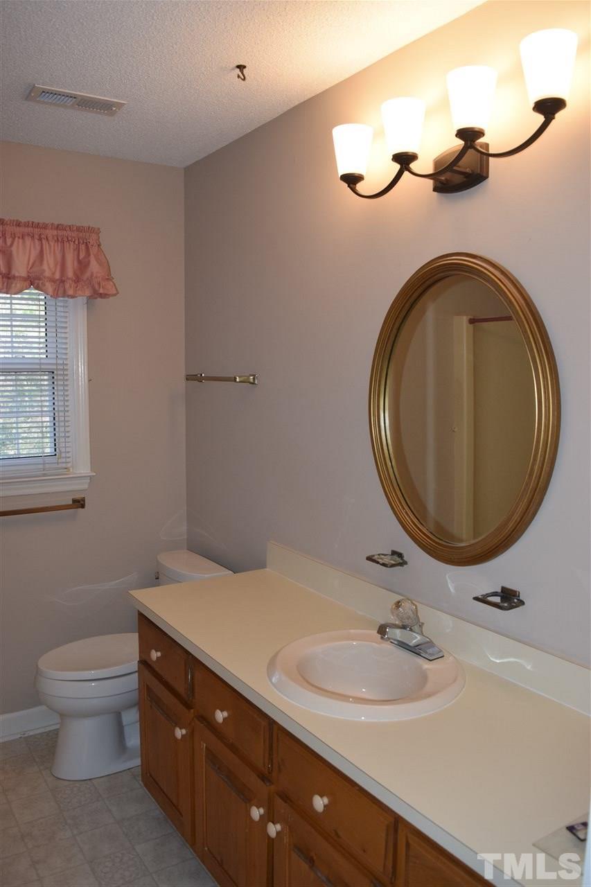 2020 Umstead Road Durham, NC 27712 - Photo 14 of 25 a bathroom with a toilet sink and mirror