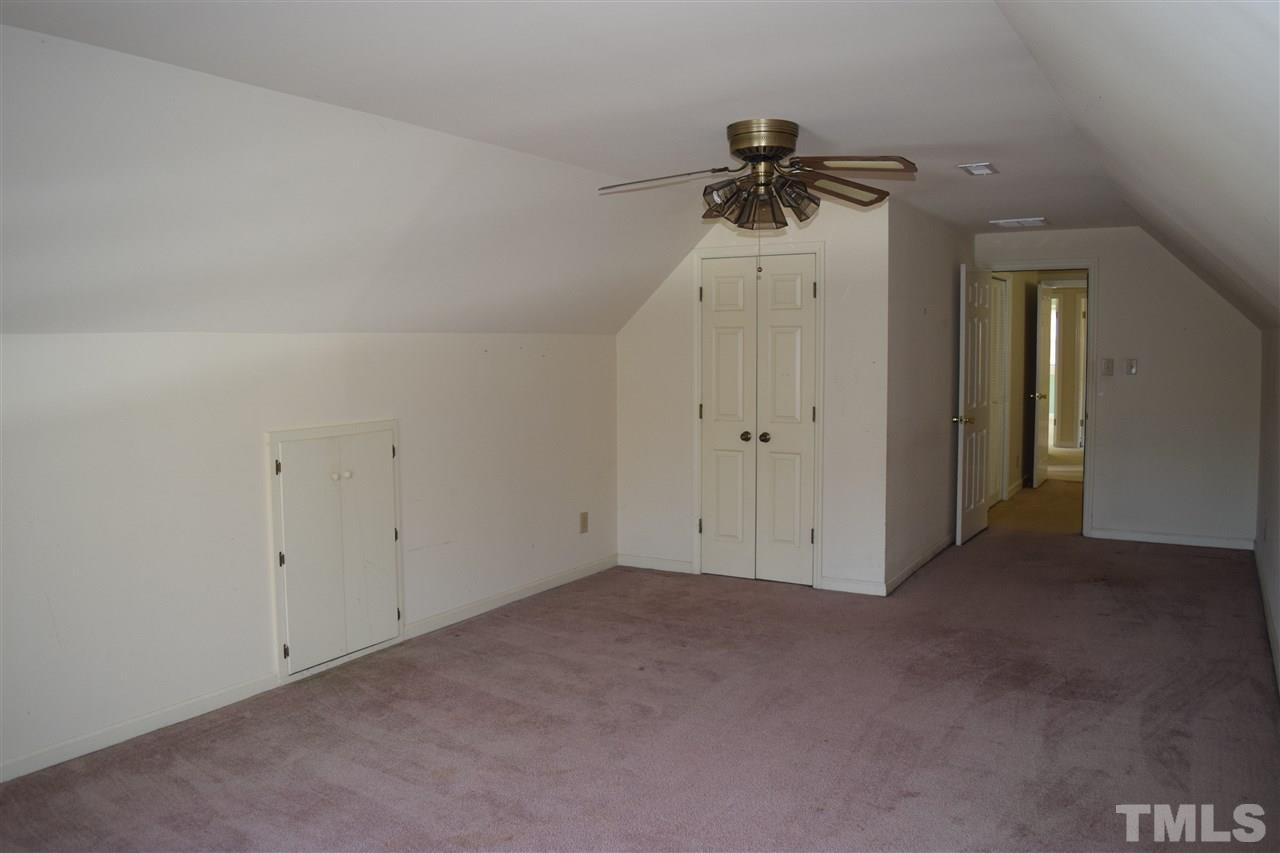2020 Umstead Road Durham, NC 27712 - Photo 22 of 25 an empty room with a ceiling fan and window