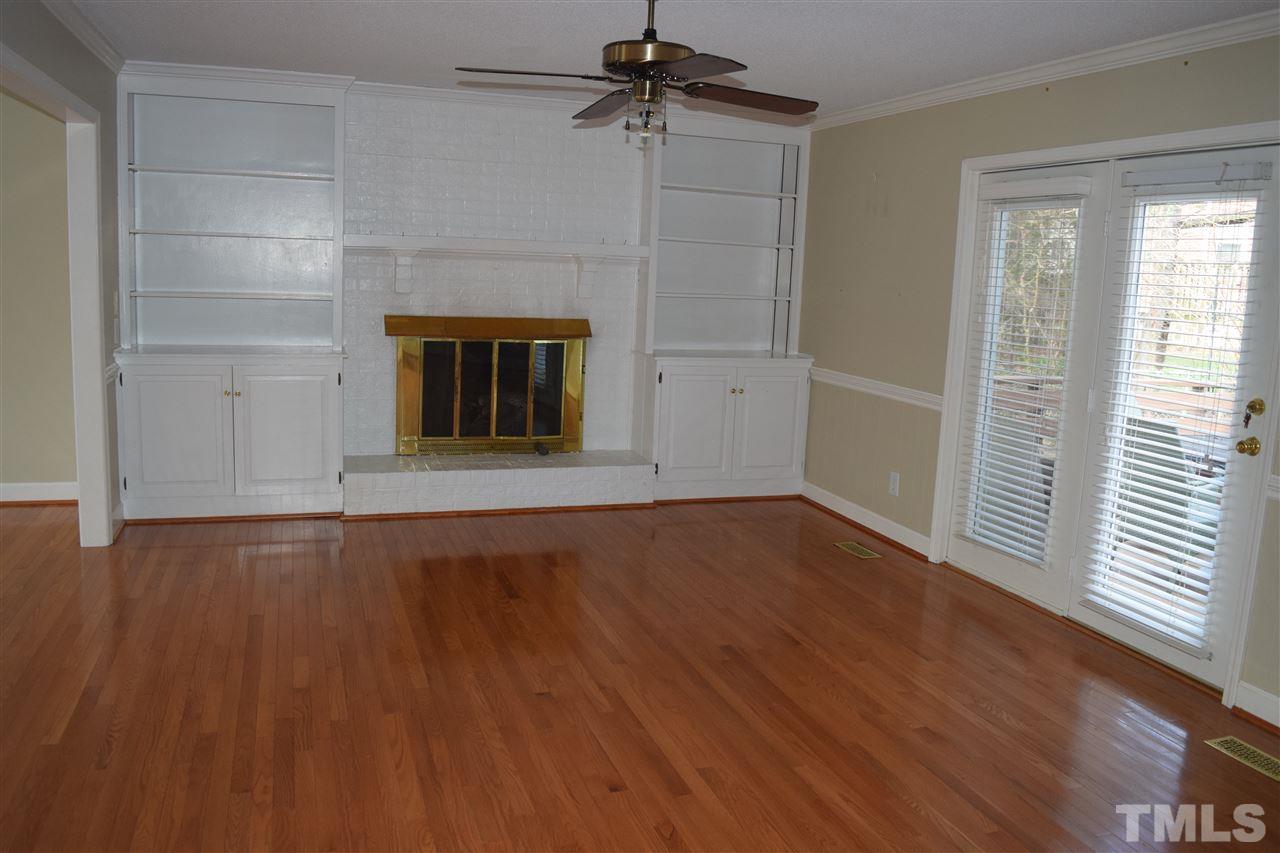 2020 Umstead Road Durham, NC 27712 - Photo 8 of 25 an empty room with wooden floor a ceiling fan and windows