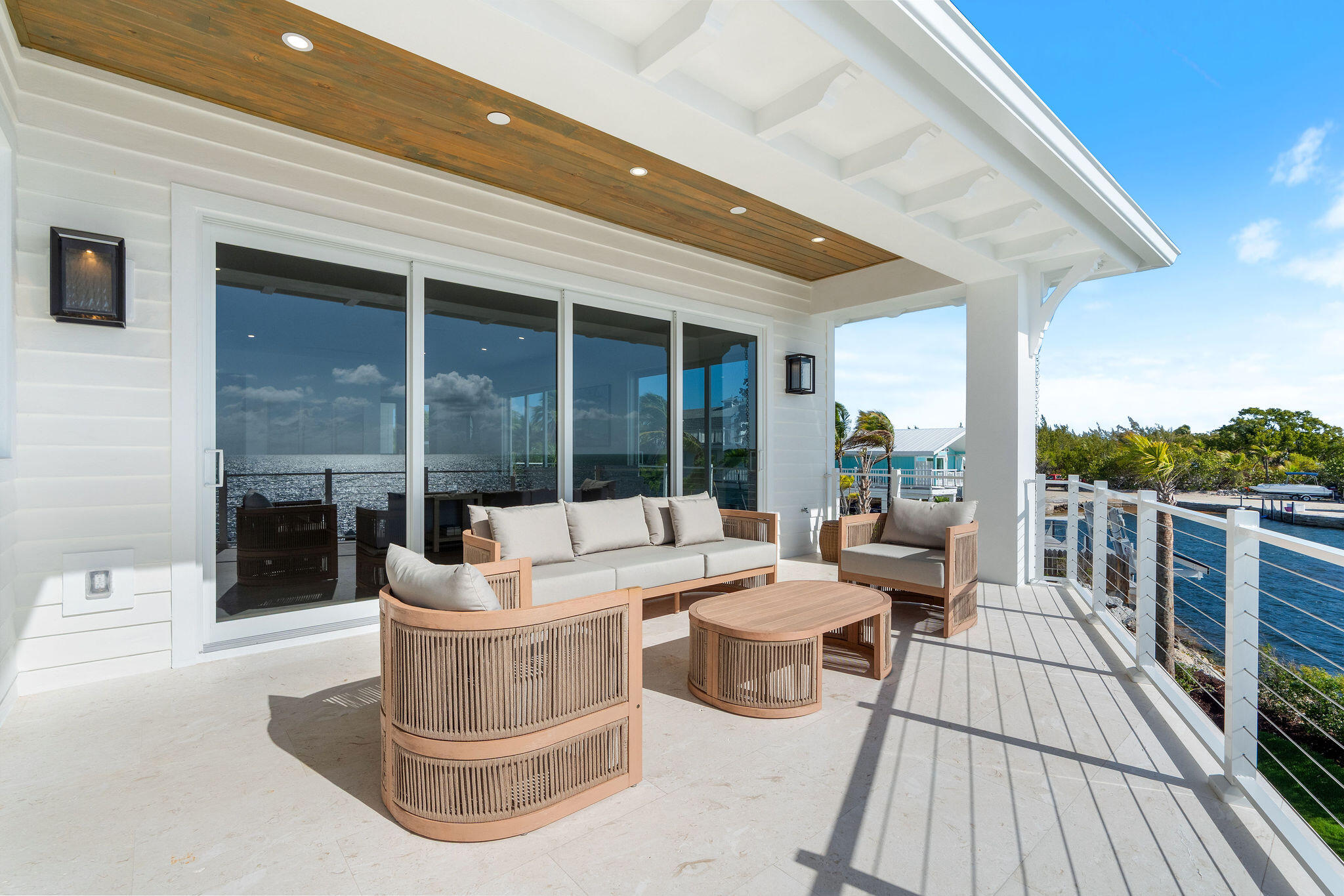 1002 Snapper Lane Key Largo, FL 33037 - Photo 58 of 106 a view of a patio with couches potted plants and a floor to ceiling window