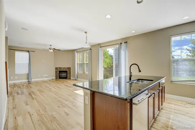 a kitchen with granite countertop a sink and stove