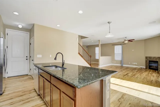 a kitchen with a sink and a refrigerator