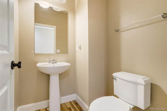 a bathroom with a sink toilet and a mirror