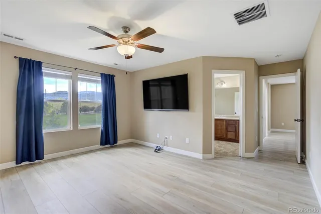 a view of a livingroom with a ceiling fan and window