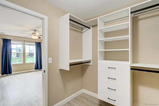 a view of an empty room with cabinet and a window