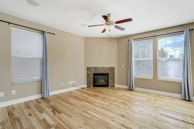 a view of empty room with window and fireplace