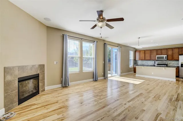 a view of an empty room with a fireplace and a window