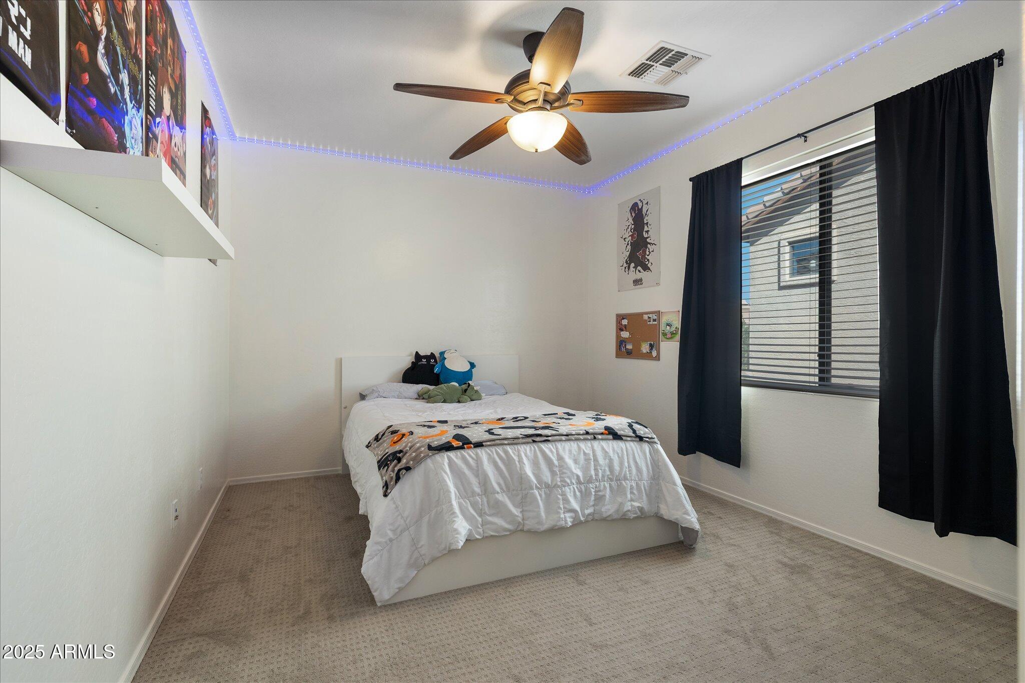 8536 East Inca Street Mesa, AZ 85207 - Photo 31 of 44 a bedroom with a bed and a chandelier