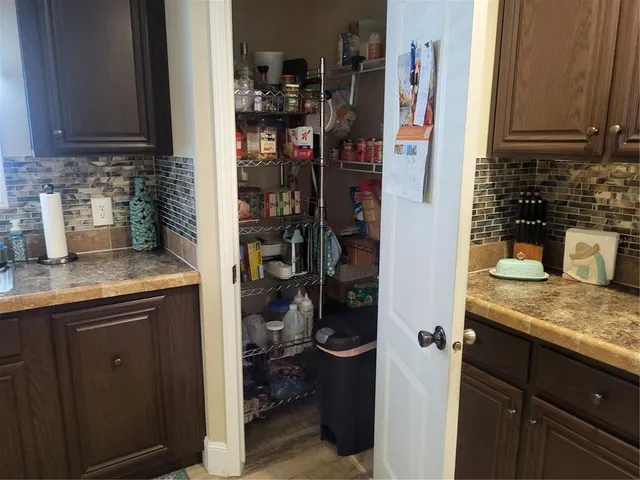 a kitchen with a refrigerator and cabinets