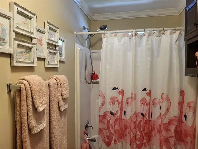 a bathroom with a shower curtain and a window