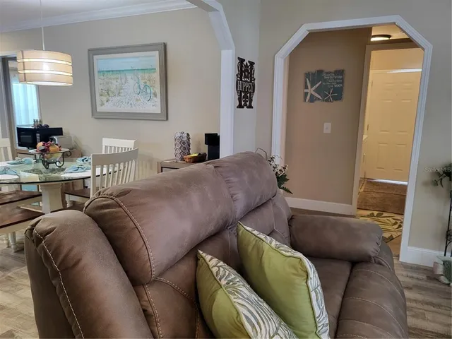 a living room with furniture and a mirror
