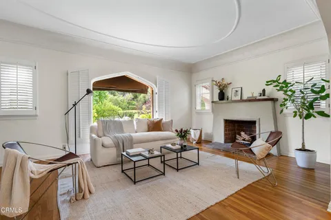 a living room with furniture and a potted plant