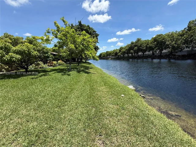 a front view of a house with a garden and garage