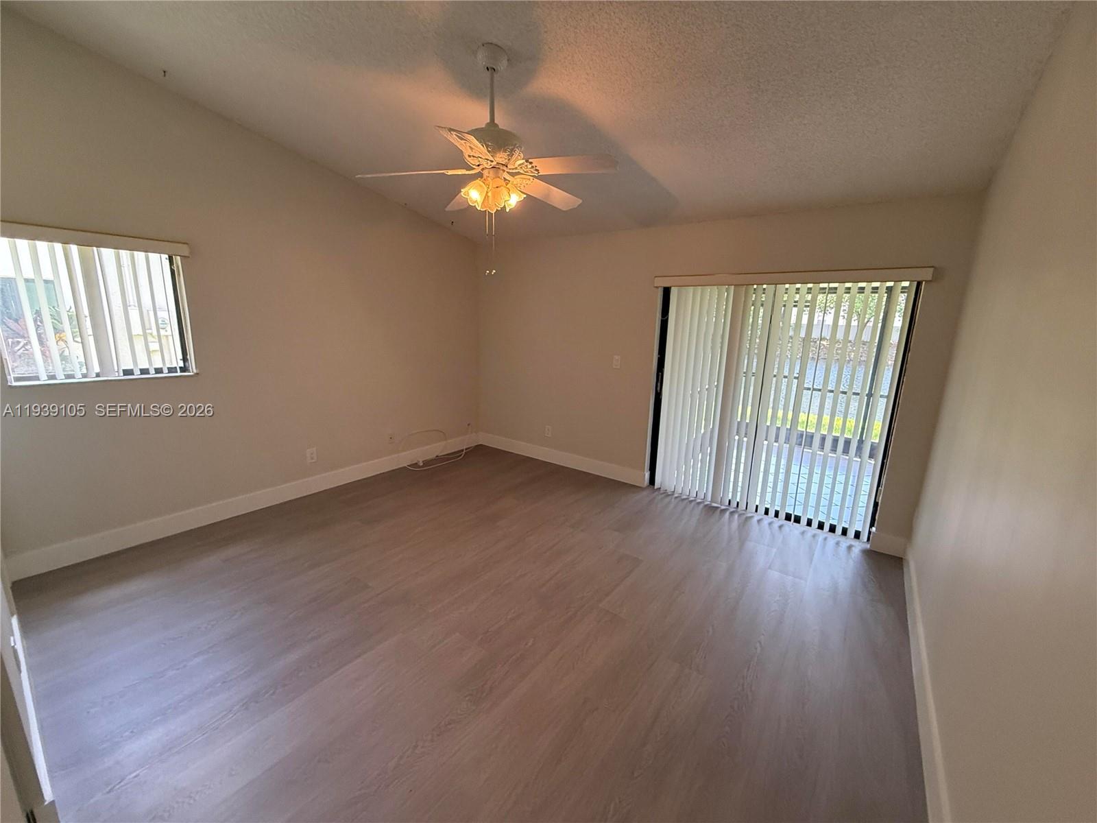 7808 Northwest 60th Street Tamarac, FL 33321 - Photo 18 of 26 a view of an empty room with wooden floor and a window