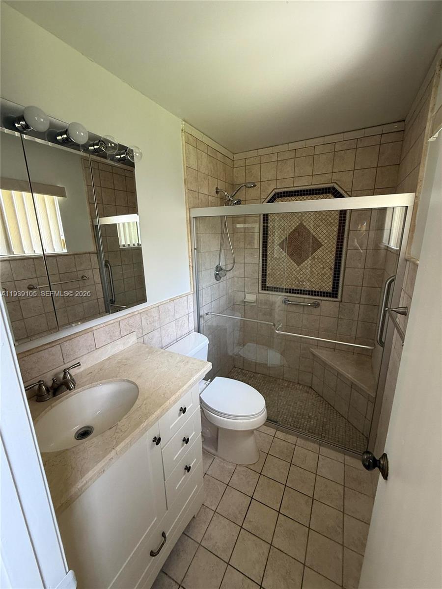 7808 Northwest 60th Street Tamarac, FL 33321 - Photo 19 of 26 a bathroom with a sink toilet and shower