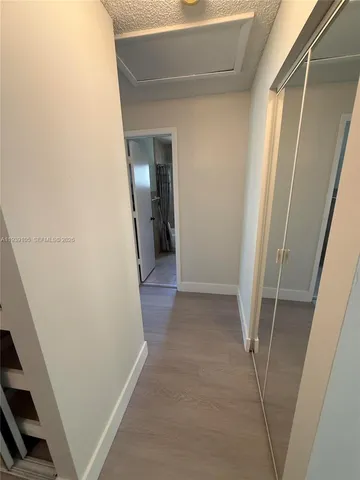 a bathroom with a walk in closet and mirror