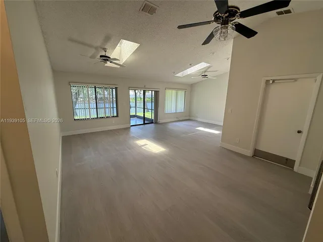 a kitchen with stainless steel appliances granite countertop a refrigerator a sink dishwasher a stove and a refrigerator