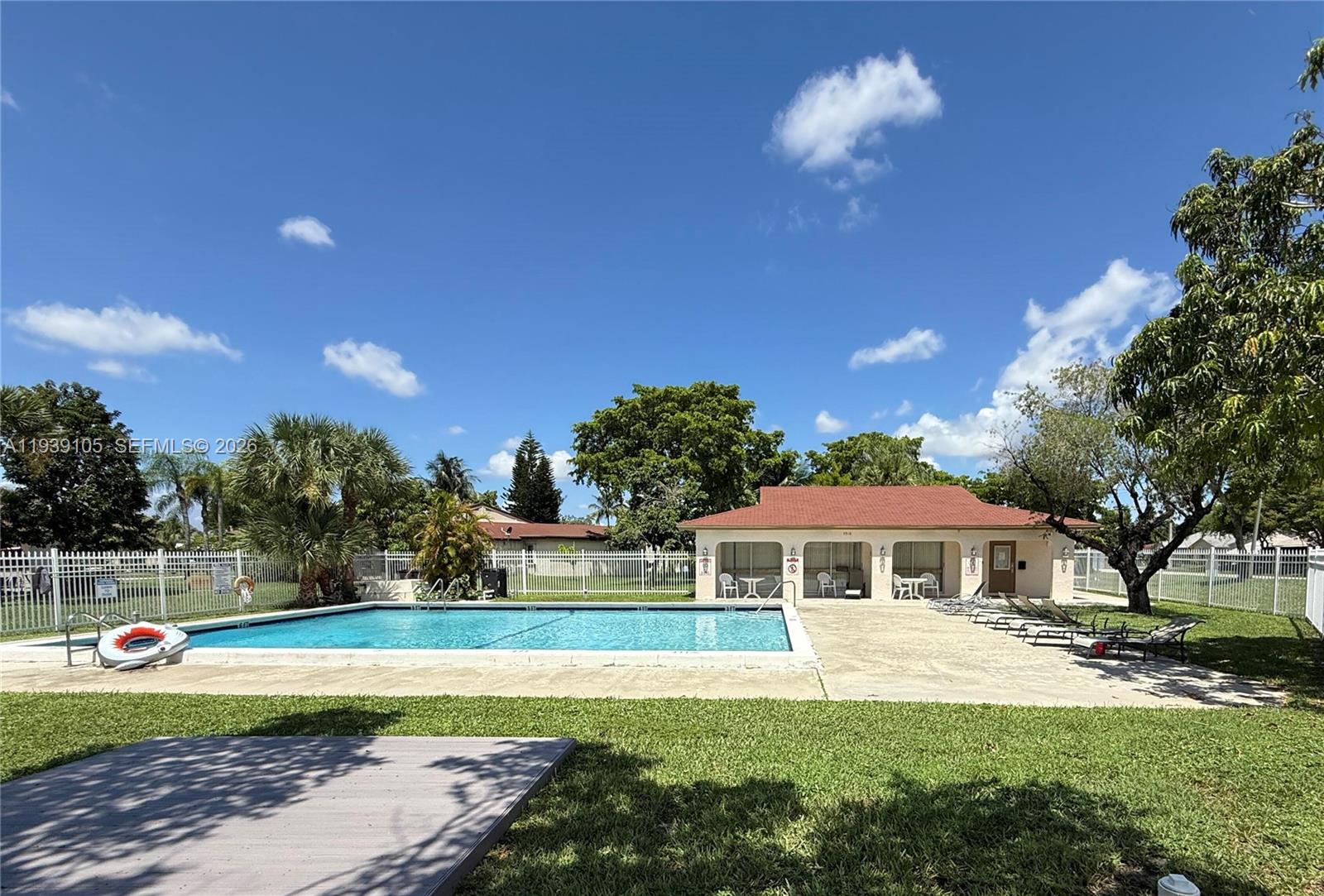 7808 Northwest 60th Street Tamarac, FL 33321 - Photo 5 of 26 a front view of a house with a yard