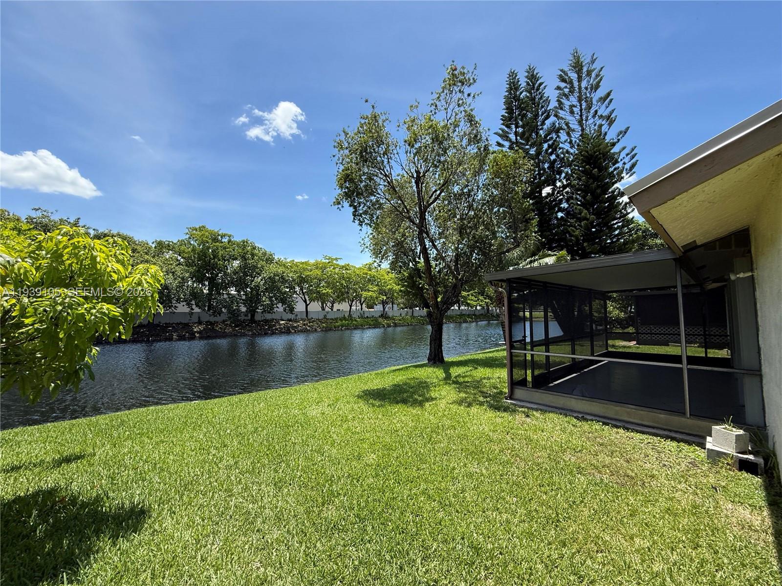 7808 Northwest 60th Street Tamarac, FL 33321 - Photo 9 of 26 a view of a house with a yard and a fountain
