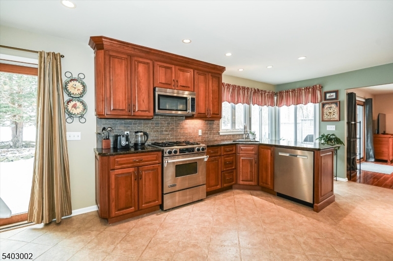 45 Indian Road Wayne, NJ 07470 - Photo 13 of 30 a large kitchen with stainless steel appliances granite countertop a stove a sink and a microwave
