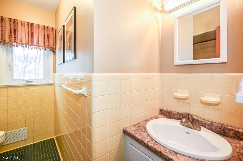 45 Indian Road Wayne, NJ 07470 - Photo 15 of 30 a bathroom with a sink and a mirror