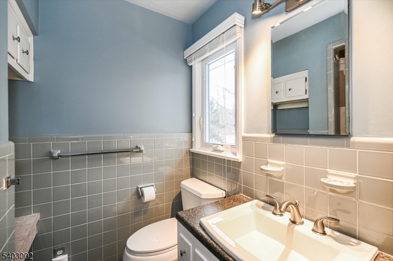 45 Indian Road Wayne, NJ 07470 - Photo 18 of 30 a bathroom with a sink toilet and mirror