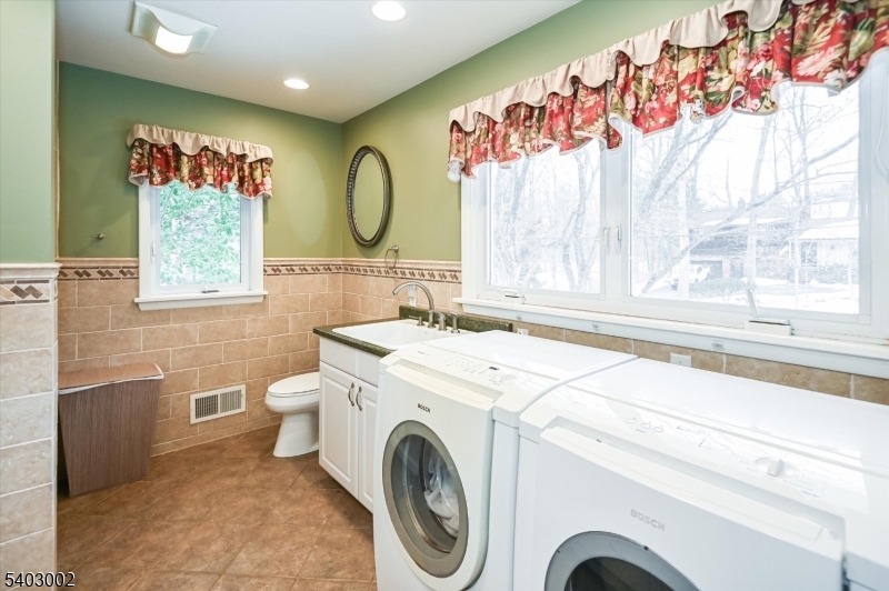 45 Indian Road Wayne, NJ 07470 - Photo 21 of 30 a bathroom with a sink a mirror and a shower