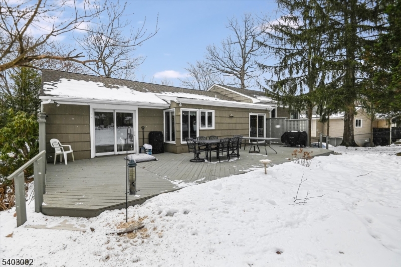 45 Indian Road Wayne, NJ 07470 - Photo 27 of 30 a view of a house with a patio covered with snow in the backyard