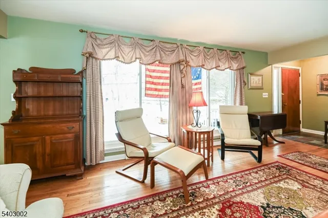 a living room with furniture a rug and a window