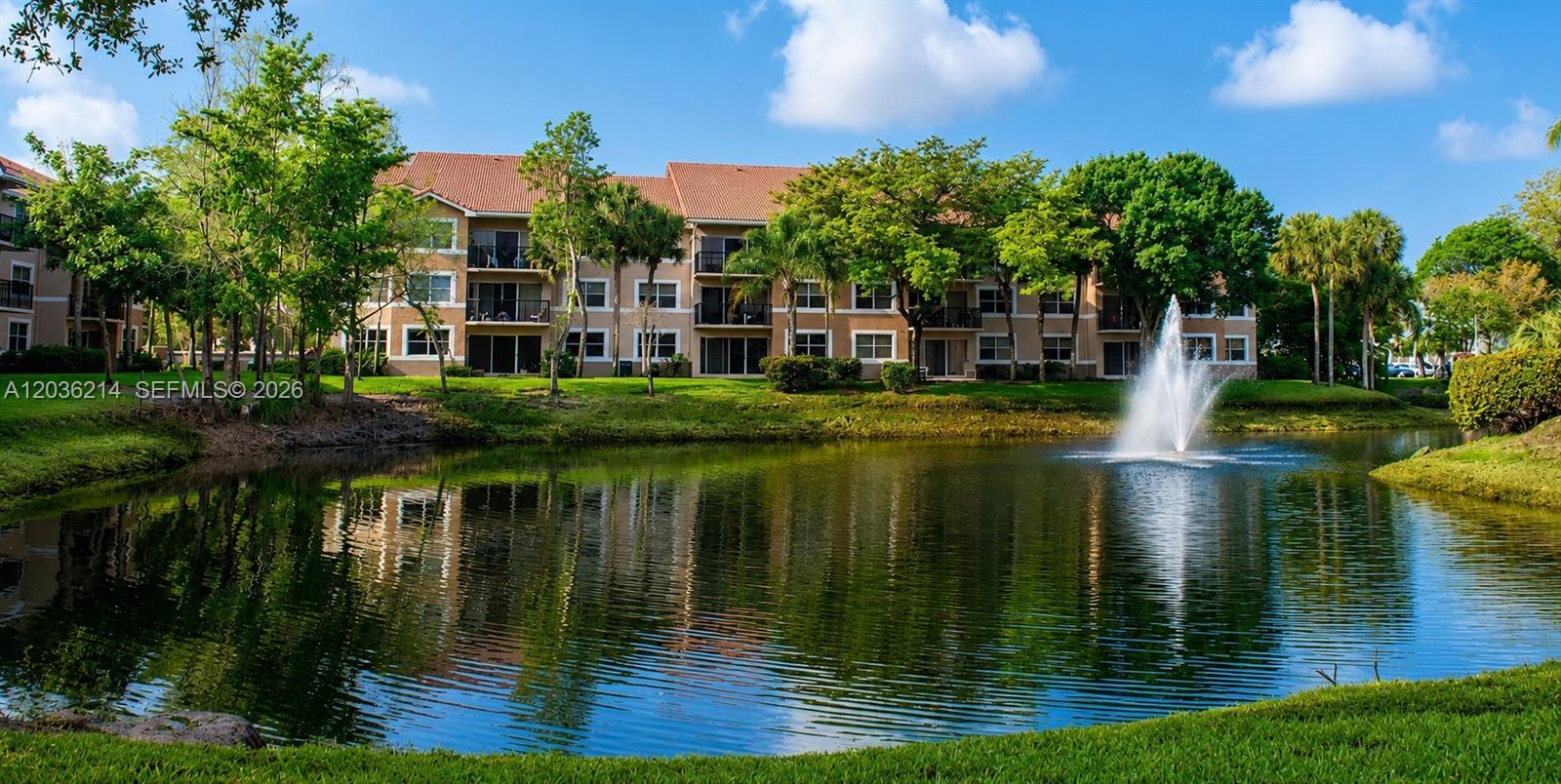 8741 Wiles Road, Unit 204 Coral Springs, FL 33067 - Photo 12 of 16 a view of a lake with a house in the background