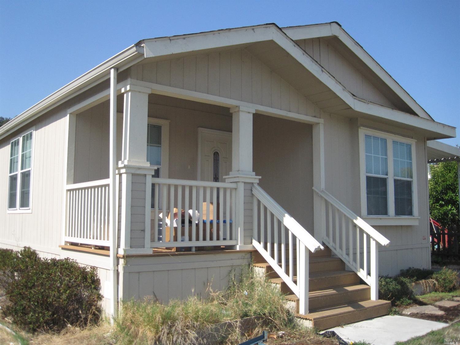 299 Yosemite Road, Unit 299 San Rafael, CA 94903 - Photo 1 of 1 a view of a house with a small yard and wooden floor and fence