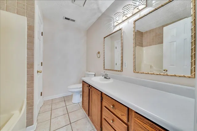 a bathroom with a double vanity sink and mirror