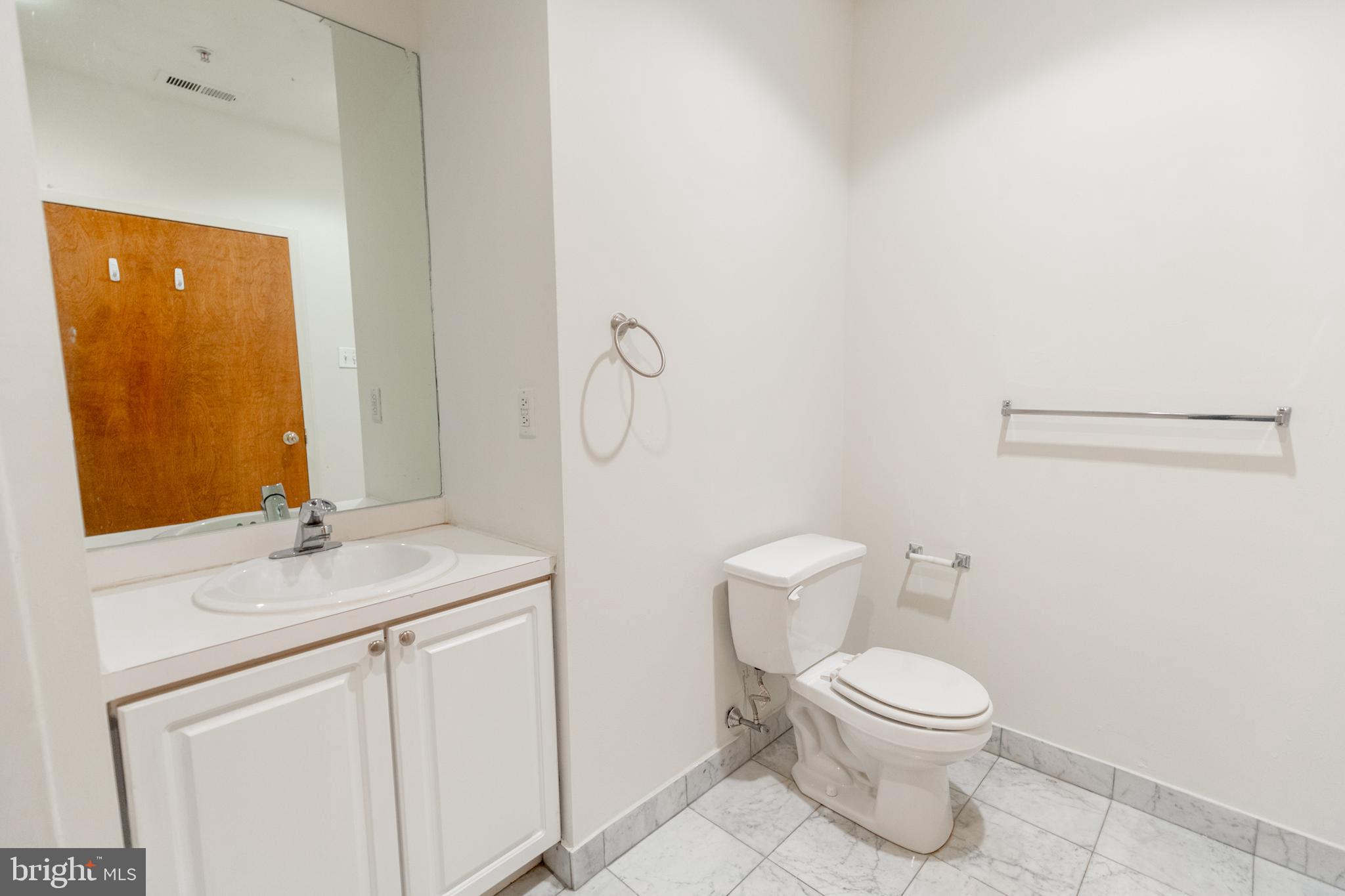 1411-1 Walnut Street, Unit 1005 Philadelphia, PA 19102 - Photo 26 of 27 a white toilet sitting next to a bathroom sink