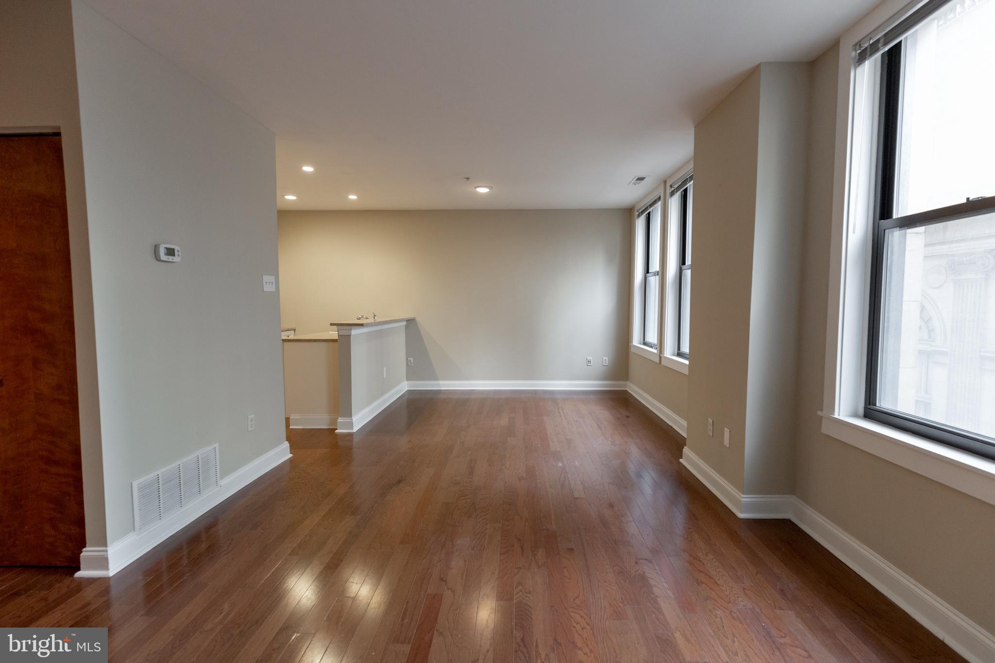 1411-1 Walnut Street, Unit 1005 Philadelphia, PA 19102 - Photo 9 of 27 wooden floor in an empty room with a window