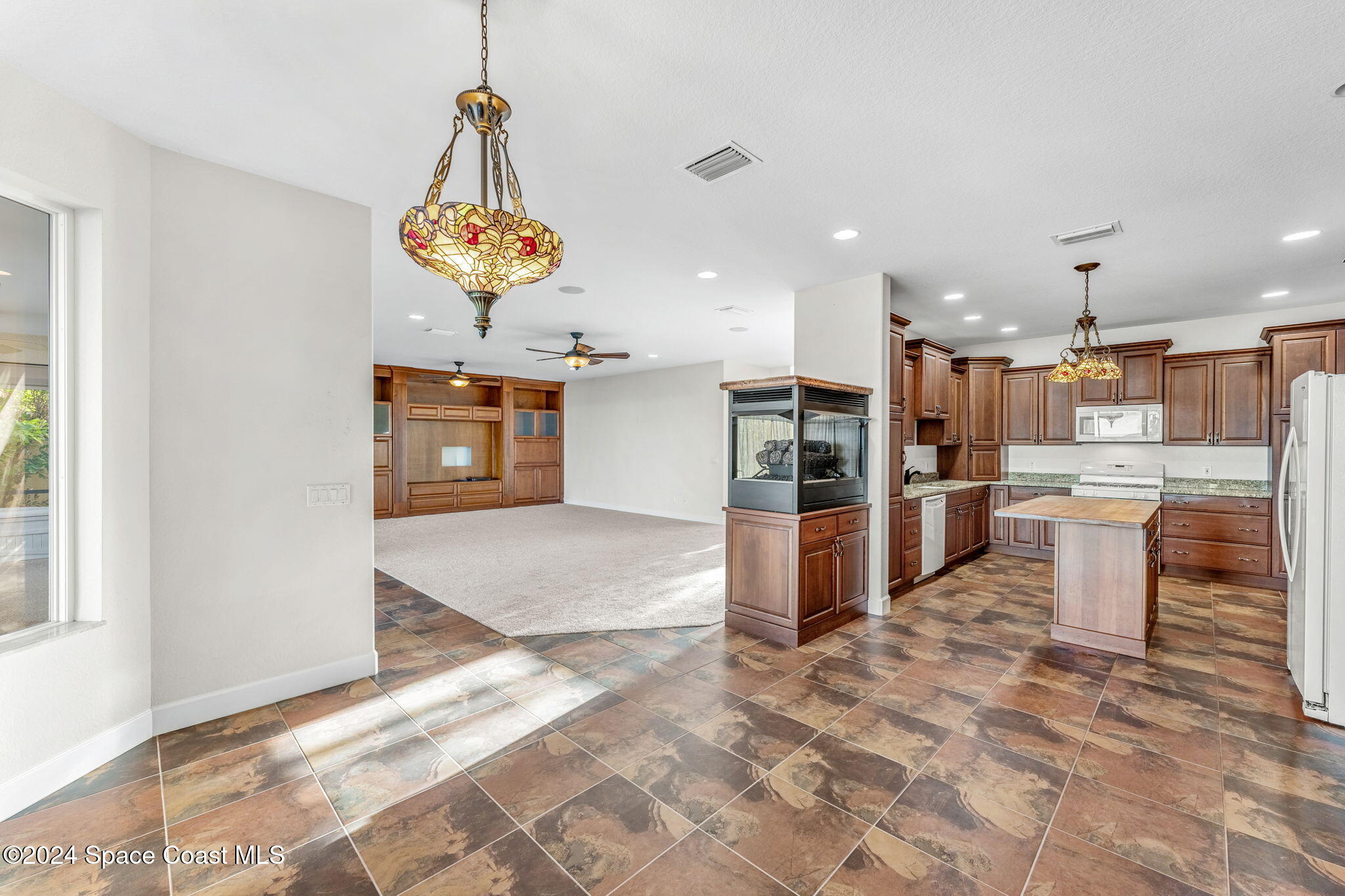 1600 Elm Drive West Melbourne, FL 32935 - Photo 14 of 79 a kitchen with stainless steel appliances kitchen island granite countertop a sink and cabinets